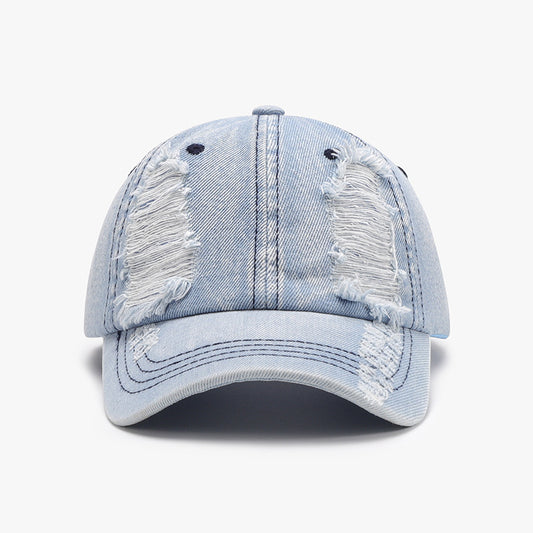 Distressed cotton baseball cap with faded denim look and frayed detailing, offering a stylish and casual accessory.