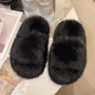 Plush Black Faux Fur Slippers on Cream Background