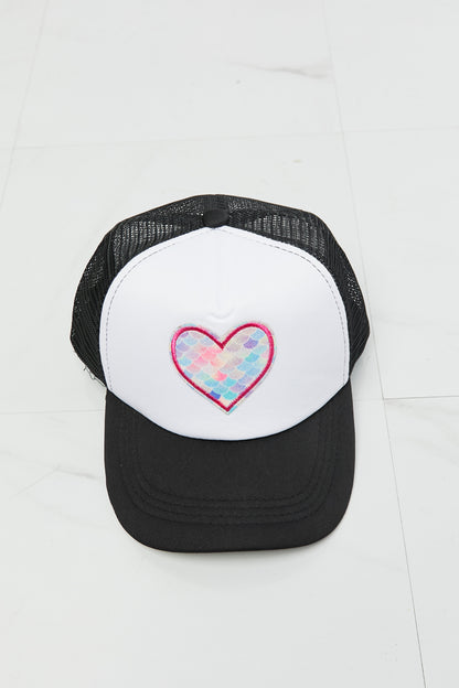 Stylish black and white trucker hat with colorful heart design, perfect casual accessory.