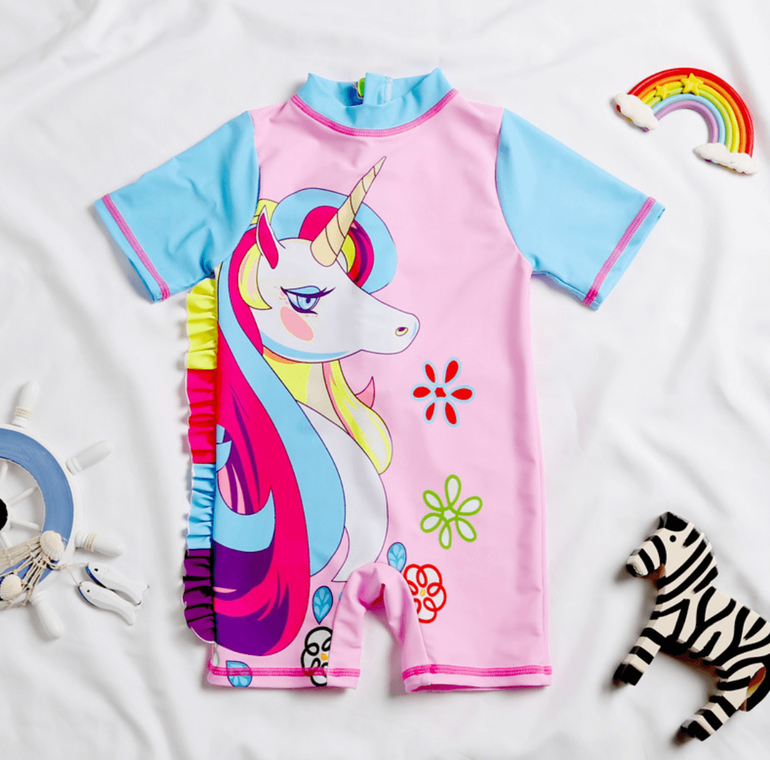 Colorful and whimsical unicorn-themed children's swimsuit, featuring vibrant floral and geometric designs on a pink and blue background. A fun, playful item perfect for a young girl's summer wardrobe.