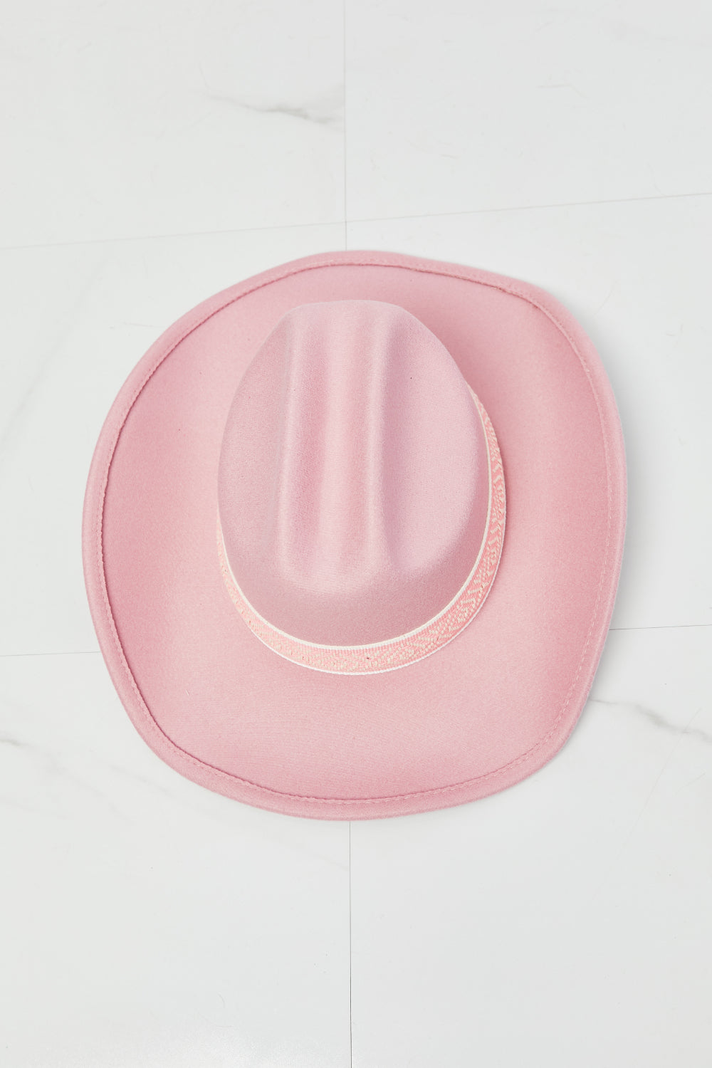 Stylish pink Western cowboy hat with feminine design details, perfect for adding a touch of country chic to any outfit.