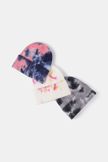 Tie-Dye Cuffed Rib-Knit Beanie Hat by Trendsi - Trendy winter accessory featuring abstract tie-dye patterns in navy, pink, and yellow.