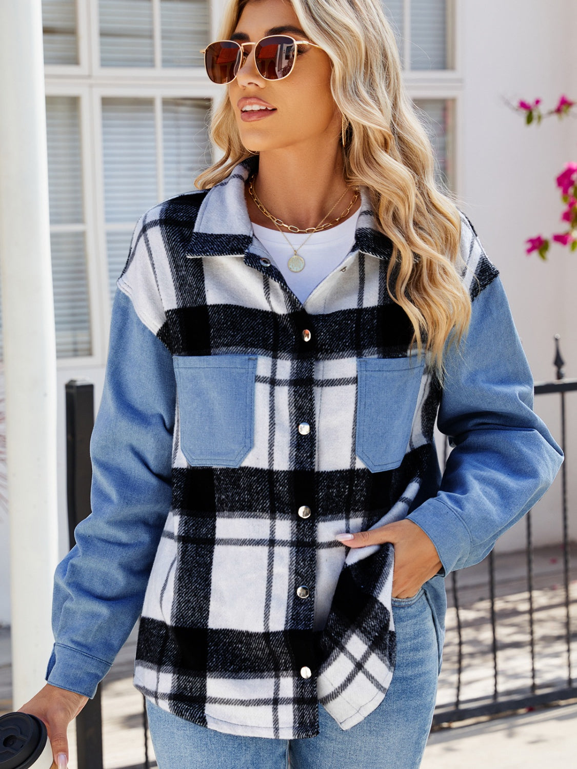 Stylish plaid snap-down denim jacket with pockets, worn by a fashionable woman with sunglasses standing in a sunny setting.