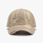 Distressed adjustable cotton baseball cap with a beige tone and a weathered, ripped appearance.