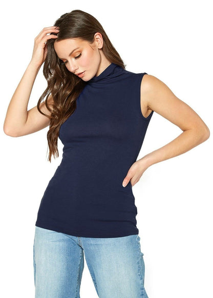 Sleeveless navy blue turtle neck top from Lemon Hera worn by a young woman with long wavy hair against a white background.