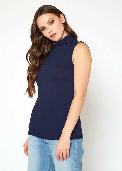 Elegant navy blue sleeveless turtleneck top, model showcased against plain background