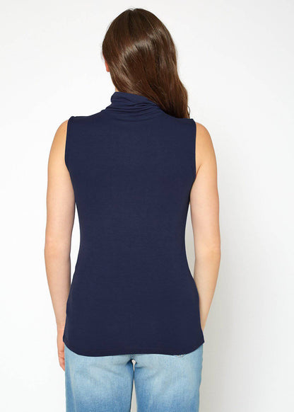 Navy blue sleeveless fitted women's turtleneck top on a model with long dark hair