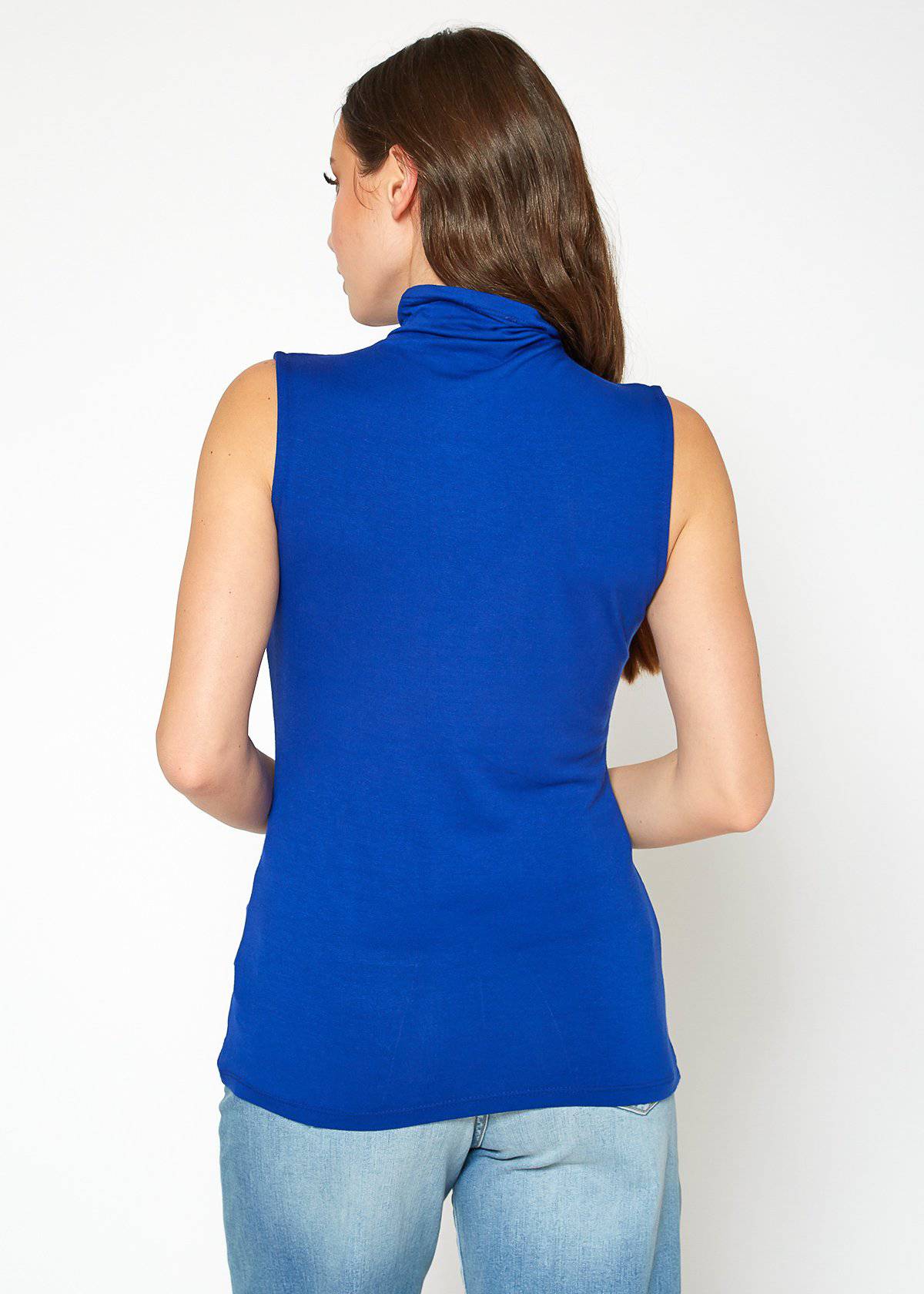 Sleeveless blue turtleneck top on a female model with long dark hair