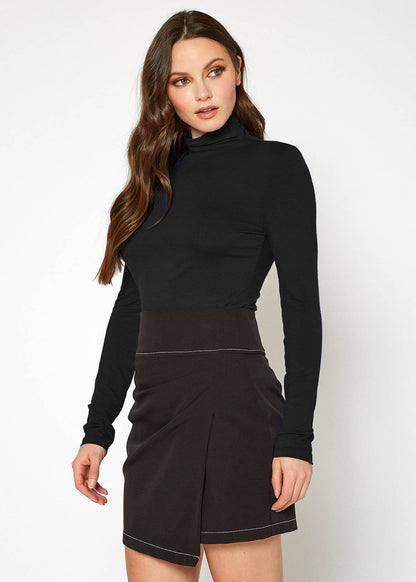 Fitted black turtleneck top with long sleeves, showcasing a young woman with long, flowing brown hair in a white studio setting.