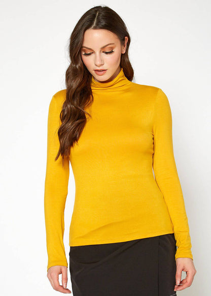 Fitted yellow turtleneck top with long sleeves, worn by a young woman with long dark hair