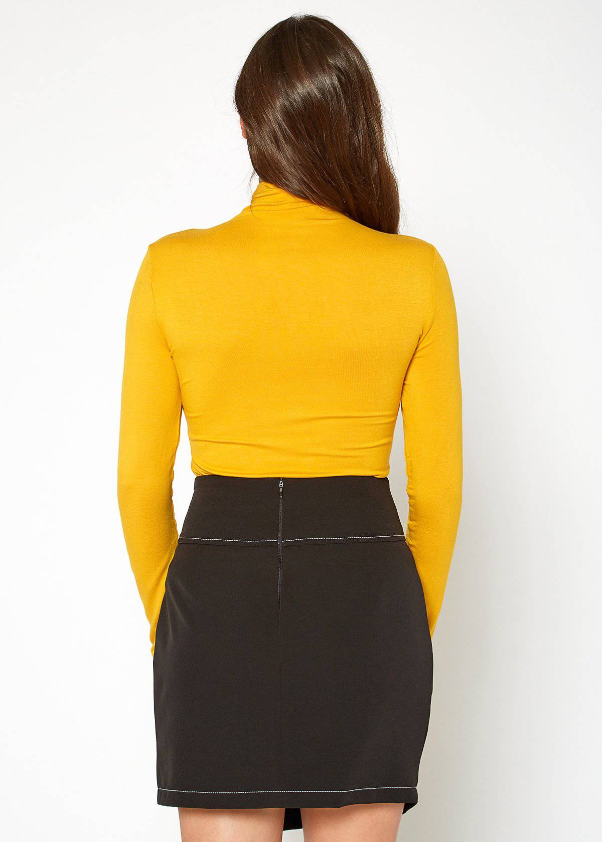 Stylish yellow women's long sleeve turtle neck fitted top against a plain white background