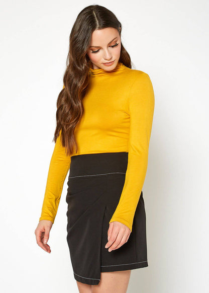 Yellow long-sleeve fitted turtleneck top with a brunette woman wearing it