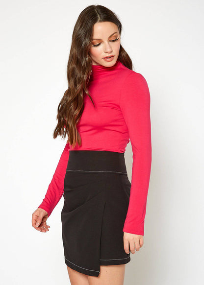 Elegant women's fitted long-sleeve red turtleneck top, part of a stylish outfit on display.