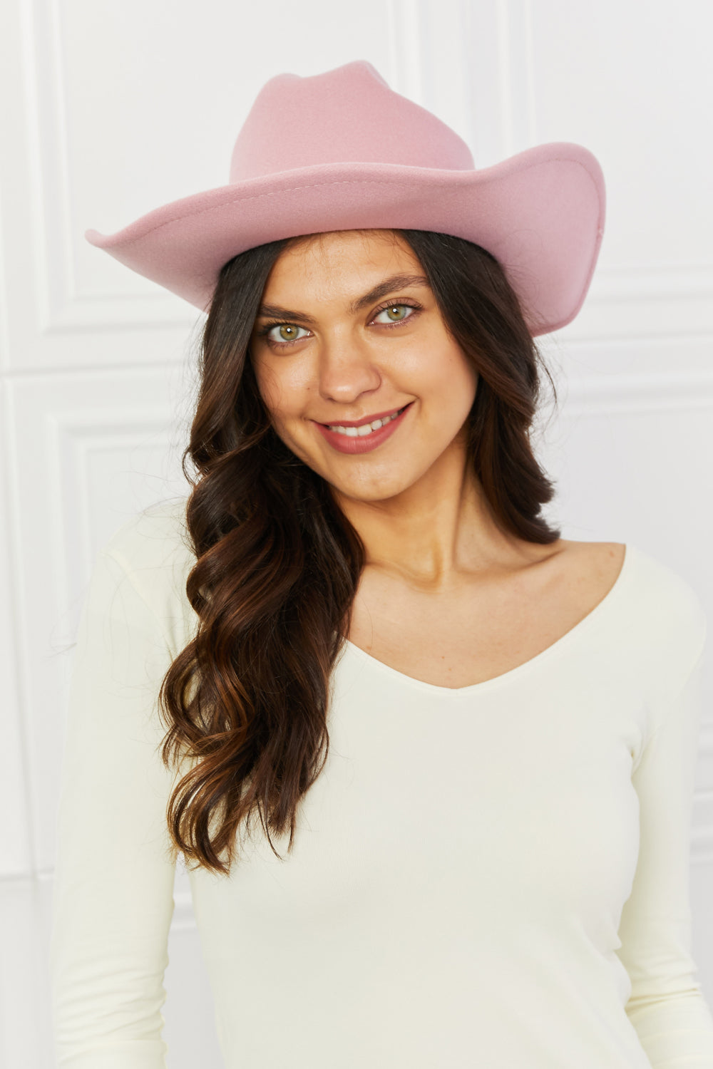 Stylish pink cowboy hat on a smiling woman's face