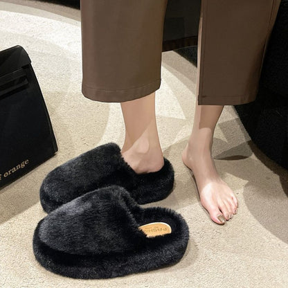 Cozy Fuzzy Round Toe Slippers - Plush black slippers on woman's feet displayed in image.