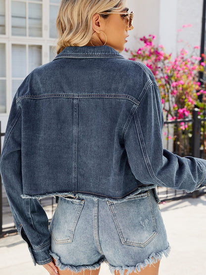 Denim jacket with button-up design and pockets, featuring a trendy, cropped silhouette ideal for casual, stylish attire.