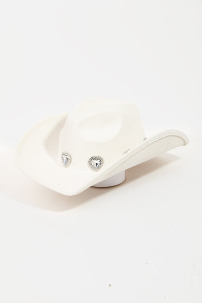 Elegant white cowboy hat adorned with sparkling rhinestone pave heart detailing, perfect for fashionable country-inspired style.