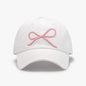 Elegant white cotton baseball cap with delicate pink bow embroidery, a stylish accessory for the fashion-conscious woman.