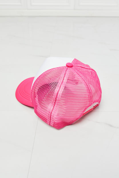 Bright pink mesh trucker hat with bow detail, perfect for casual fashion.