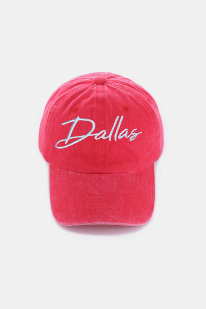 Vibrant pink baseball cap with "Dallas" embroidered in white, showcasing a casual and youthful style.