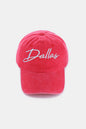 Vibrant pink baseball cap with "Dallas" embroidered in white, showcasing a casual and youthful style.