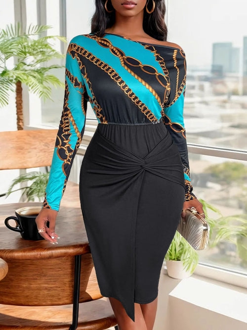 Elegant turquoise and black printed dress, long sleeves, high-waisted skirt, feminine style, sophisticated urban fashion for the modern woman.