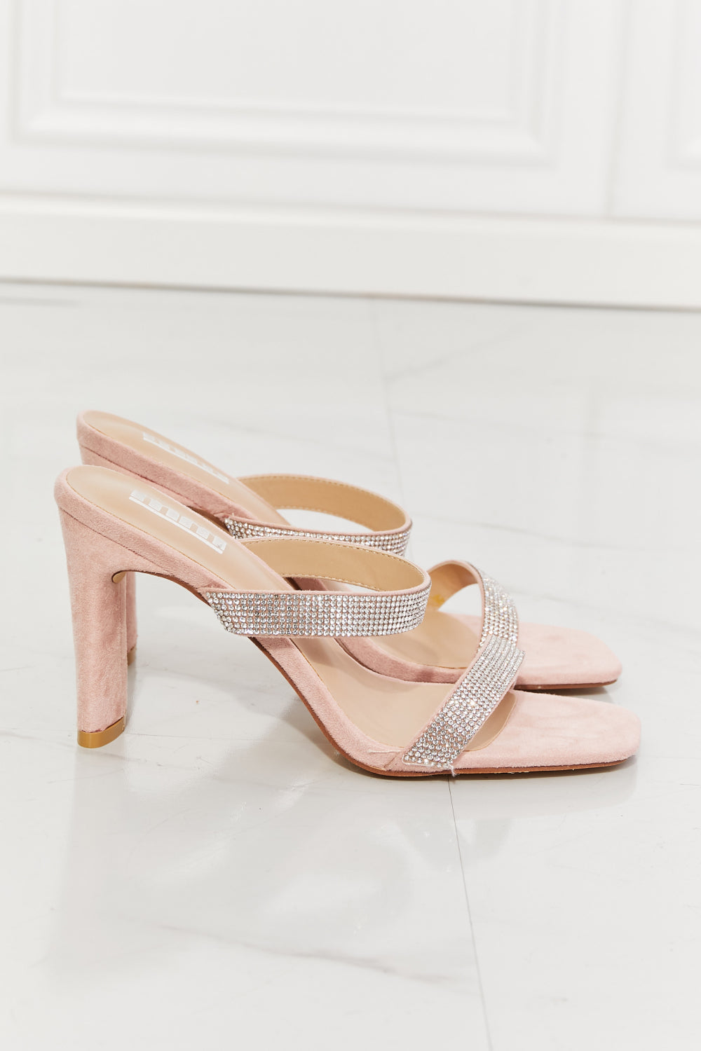 Rhinestone embellished pink block heel sandals showcased against a white background