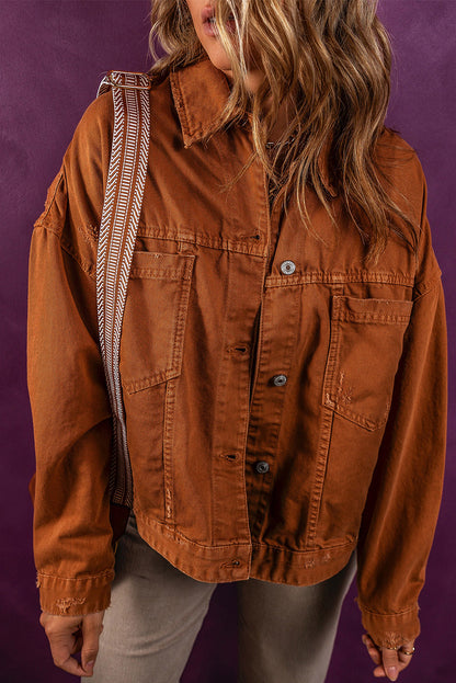 Collared button-up denim jacket in warm autumn hue, featuring waist pockets and relaxed fit.