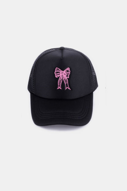 Stylish black trucker hat with embroidered pink ribbon bow design, perfect accessory for the modern fashionista.