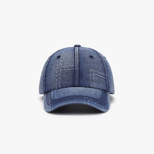 Adjustable cotton baseball cap in a stylish denim blue design with a distressed look and textured detailing.