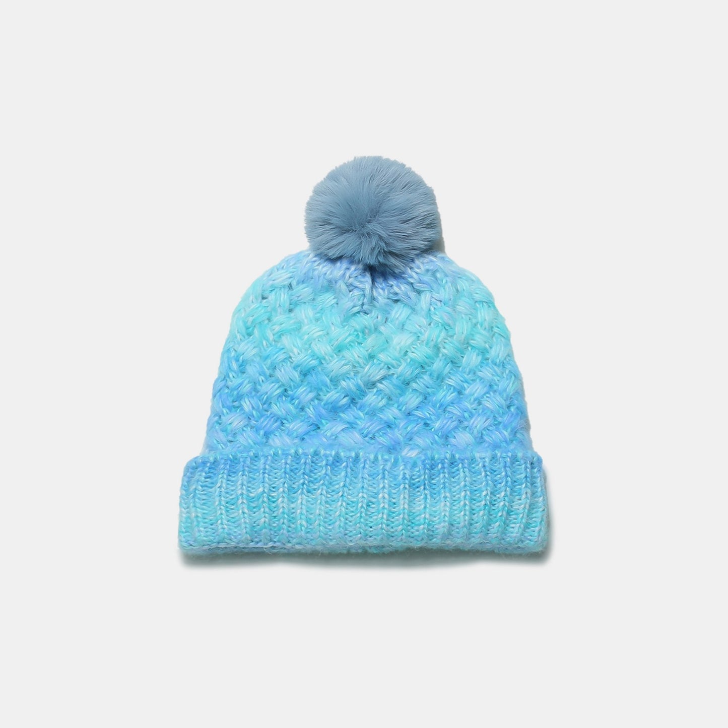 Cozy gradient knitted hat with fluffy pom-pom, perfect for keeping warm in style.