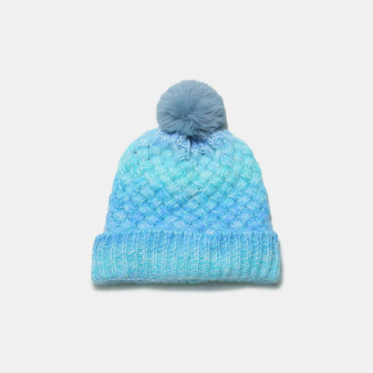 Cozy gradient knitted hat with fluffy pom-pom, perfect for keeping warm in style.