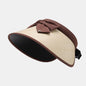 Adjustable beige straw sun hat with brown fabric detailing and brim