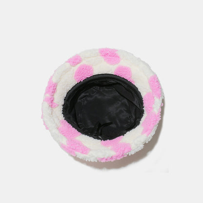 Soft, plush bucket hat with contrasting pink and white polka dot pattern, providing fashionable and cozy coverage.