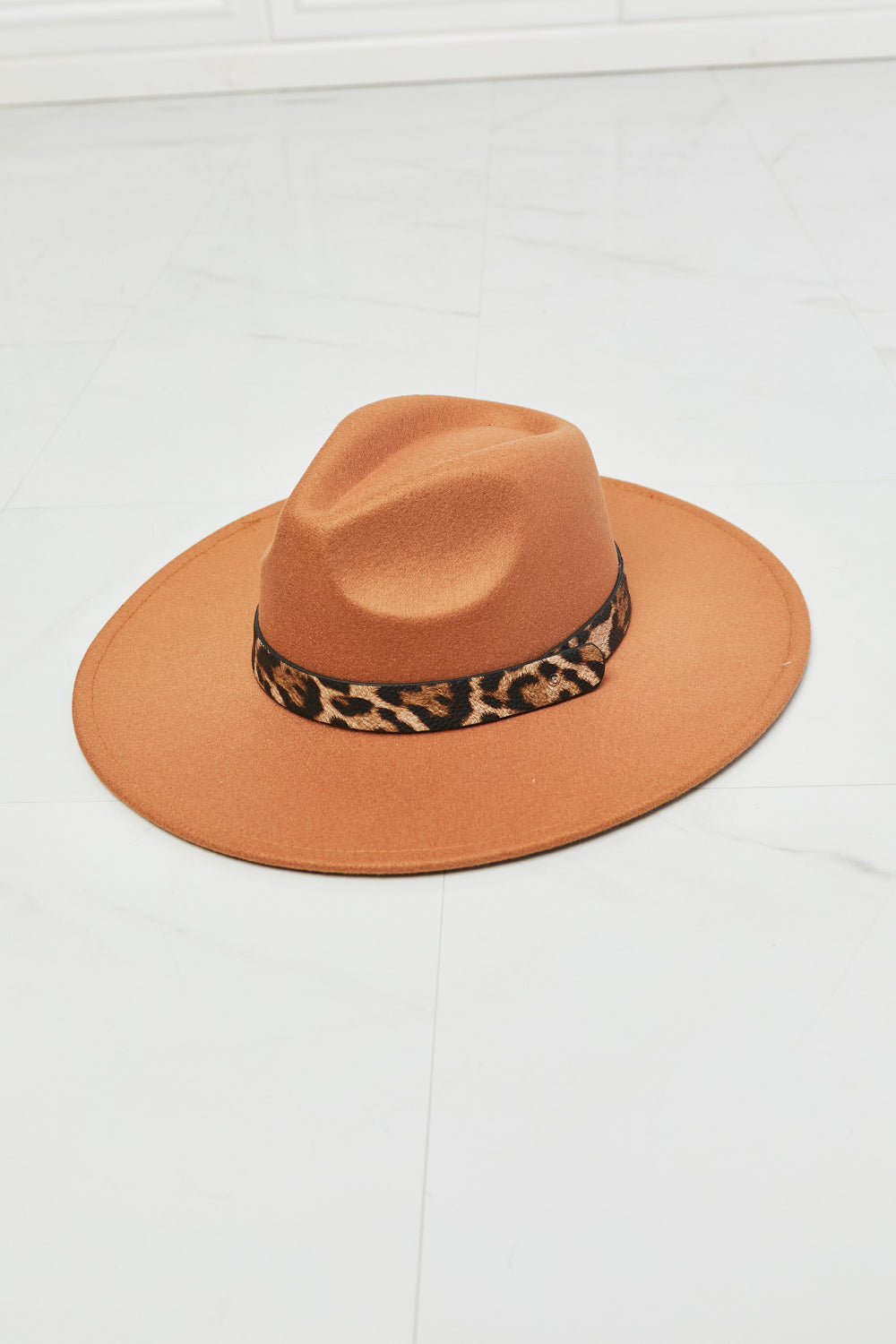 Stylish leopard-print fedora hat with a warm camel-colored wool blend body, perfect for adding a touch of chic flair to any outfit.