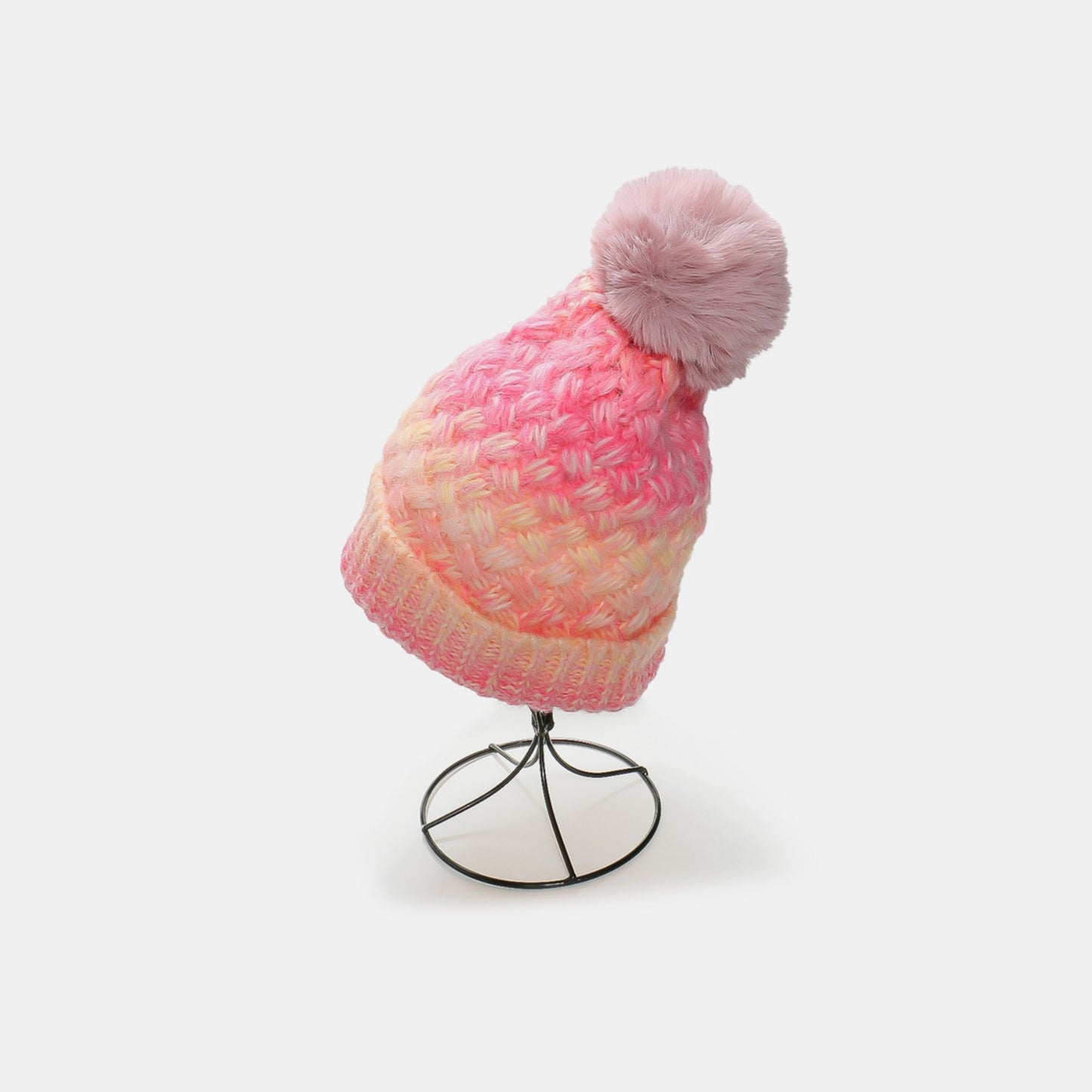 Gradient Knit Hat with Pompom - Cozy, colorful winter accessory with a plush pom-pom on top, displayed on a stand against a plain background.