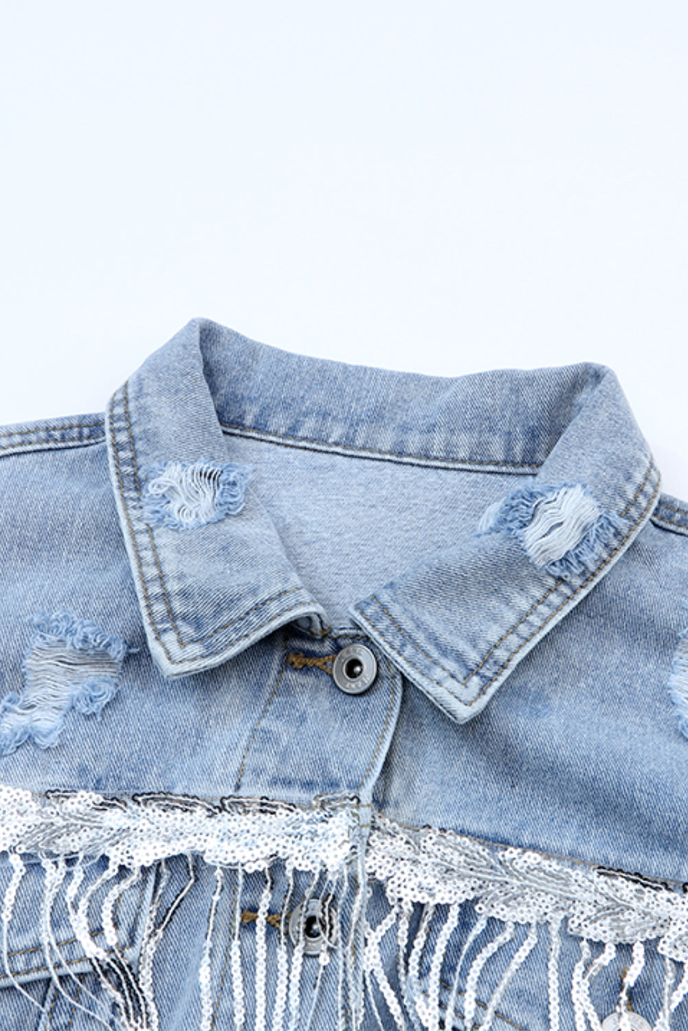 Distressed denim jacket with sequin fringe trim and button-up design