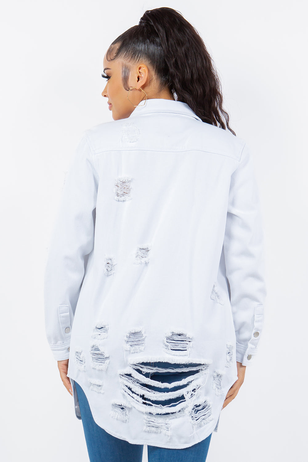 Distressed denim jacket with long sleeves and button-up design, showcasing a stylish and casual look.