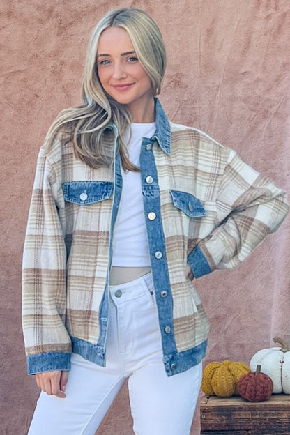 Casual plaid jacket with denim accents, complementing the model's blonde wavy hair and casual attire against a plain pink background.