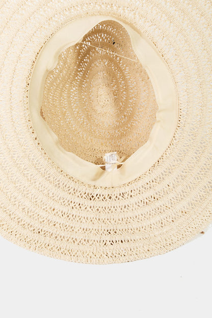 Elegant woven straw sun hat with intricate braided pattern, ideal for summer style and sun protection.