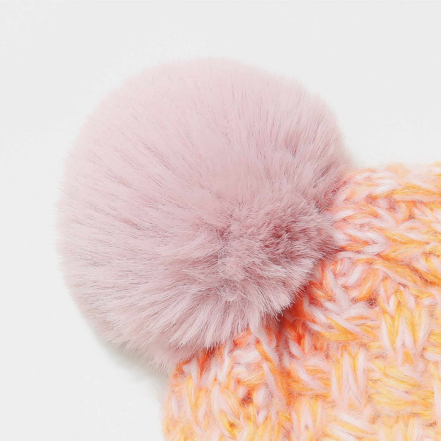 Gradient Knit Hat with Lush Pompom
A cozy, textured pink and orange knit cap adorned with a large, plush pompom in a complementary blush tone.