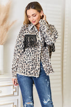 Load image into Gallery viewer, Leopard print denim jacket with fringed collar and cuffs, worn by smiling woman in distressed jeans.