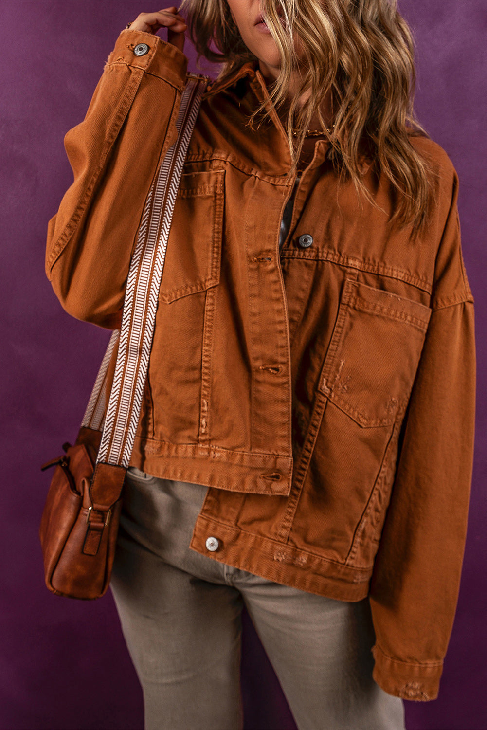 Collared button-up denim jacket, casual orange-brown design, stylish outerwear for the modern woman.