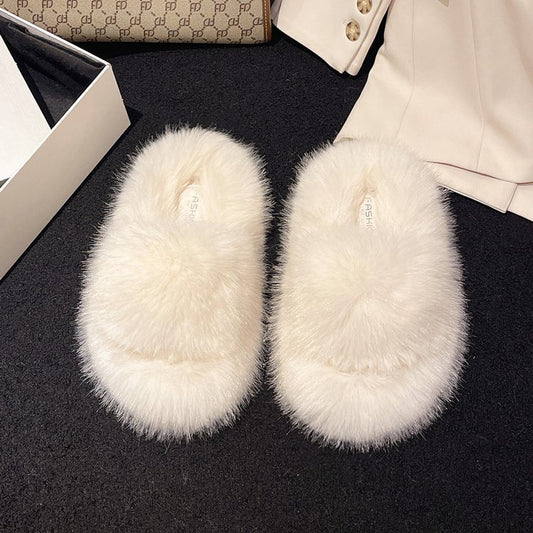 Soft, plush white fuzzy open-toe platform slippers on a black background with some fashion accessories in the image.