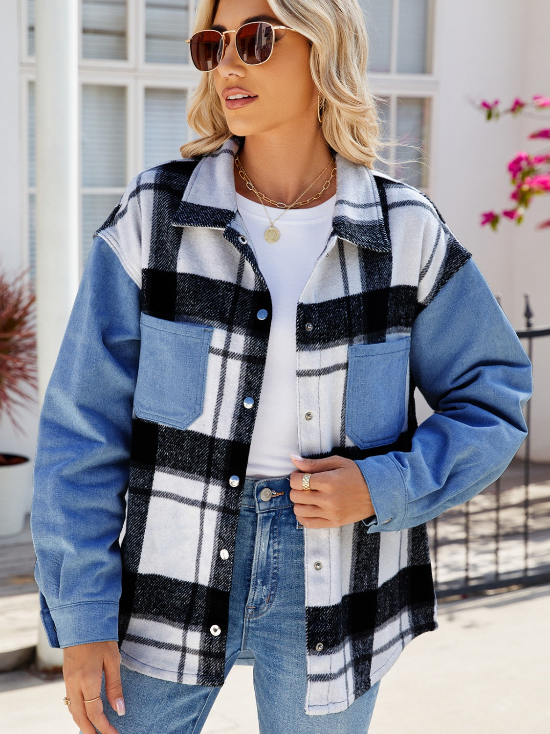 Stylish plaid snap down denim jacket with pockets, worn by a fashionable woman with sunglasses in a casual outdoor setting.