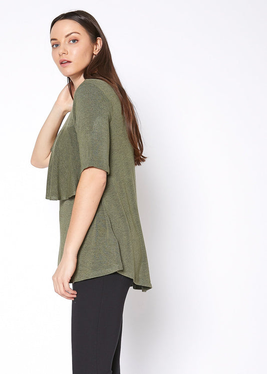 Women's mock neck olive green short sleeve ruffled yoke top by Lemon Hera, displayed on a model against a white background.