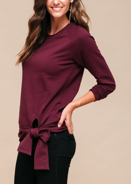 Burgundy tie-knot women's sweatshirt, casual yet stylish long sleeve top on model.