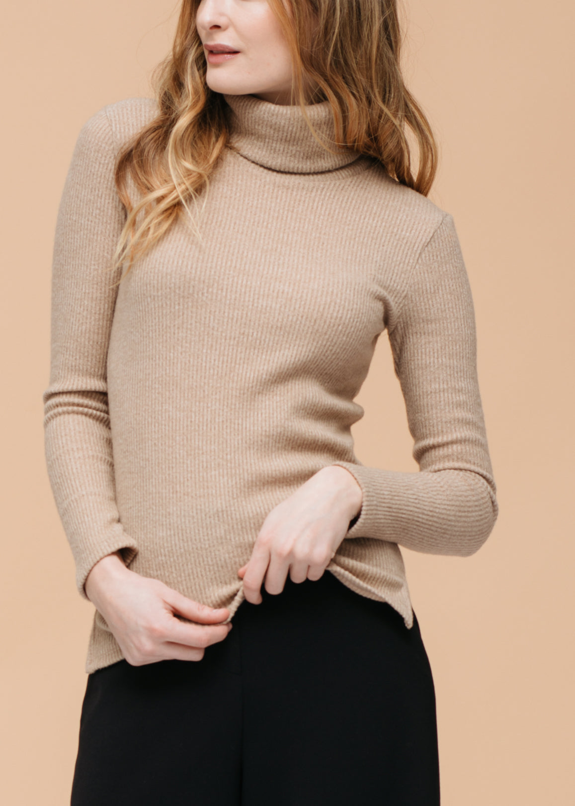 Cozy ribbed knit sweater with turtleneck for women, featuring soft beige color and long sleeves.