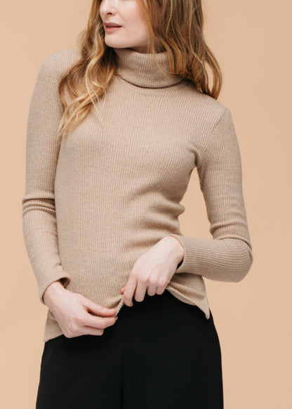 Cozy ribbed knit sweater with turtleneck for women, featuring soft beige color and long sleeves.