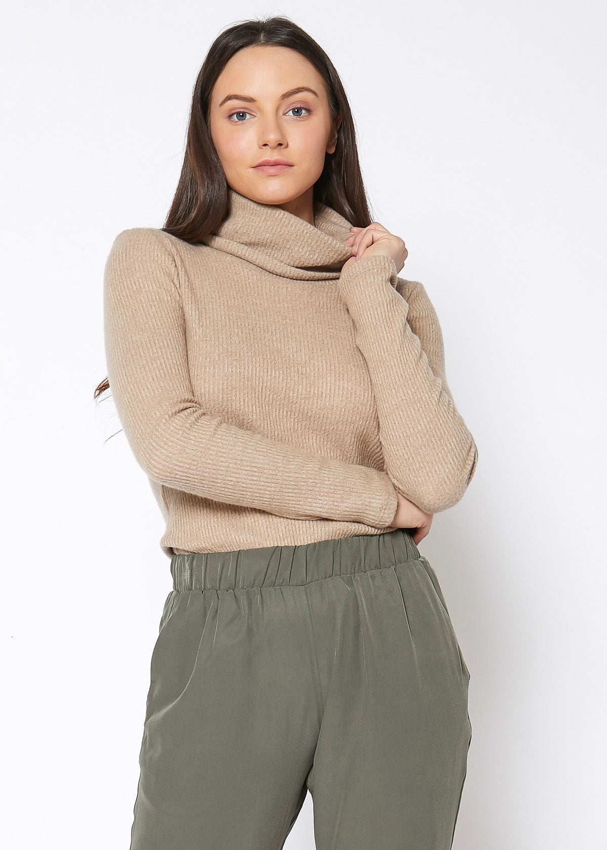 Soft ribbed knit sweater top with turtleneck collar, modeled on a young woman with long dark hair